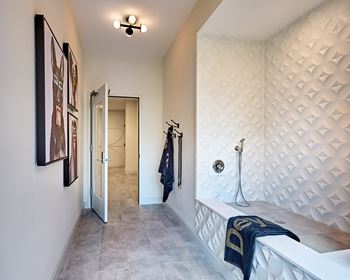 A bedroom with a bed and a hallway with a door to a closet
